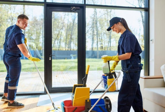 Two professional commercial janitorial crew members mopping and cleaning interior business space.