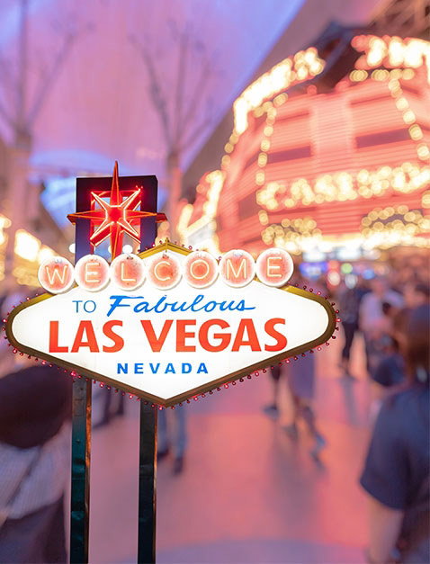 Sparkling Las Vegas Sign Amidst Busy Business Facility Buildings