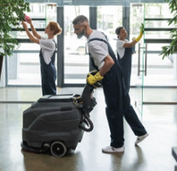 RMB Services worker cleaning and waxing the floors