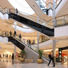 Inside view of a busy shopping mall that is clean and bright.