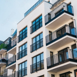 Outside view of well maintained residential high-rise apartment building.