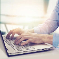 Man typing on a laptop.